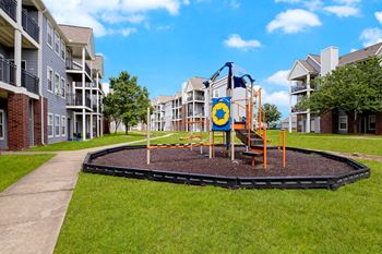 an image of a playground in front of an apartment building